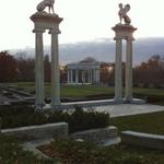 Large griffin sculptures high atop columns, guarding the ampitheater.