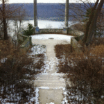 Based upon the Villa D'Este on Lake Como, a descending staircase with a grand Vista of the Palisades leads to a circular outlook featuring ancient monolithic columns.